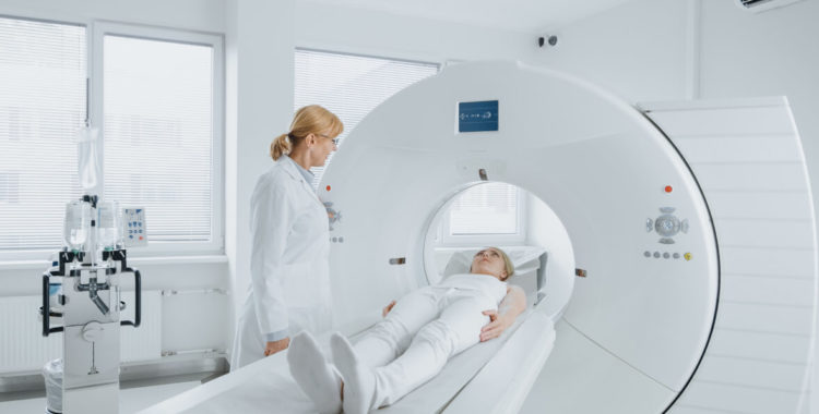 Female Radiologist Controls MRI or CT Scan with Female Patient