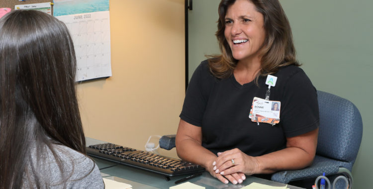 Provider helping a boy with physical therapy