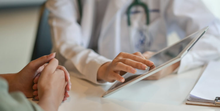 doctor showing a patient some information