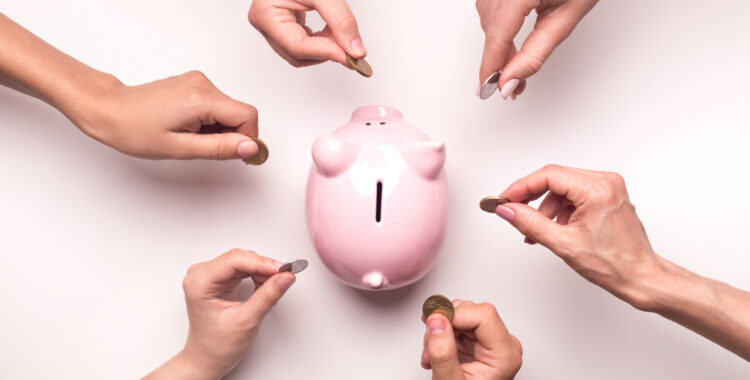 People hands throwing coins in piggy bank for crowdfunding