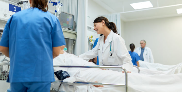 Doctors and nurses take care of patients in the post operative area.