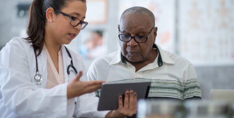 Provider showing patient something on an ipad
