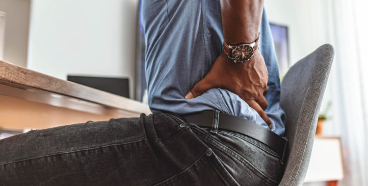 Feeling the strain of a long day at his desk
