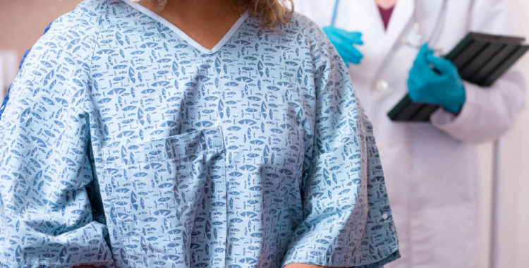 Young African American Woman prepares for breast exam, mammogram at doctor’s office or hospital.