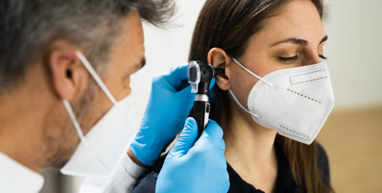 Otolaryngology Doctor Examining Patient Ear In Face Mask, ENT, Ear Nose and Throat Services