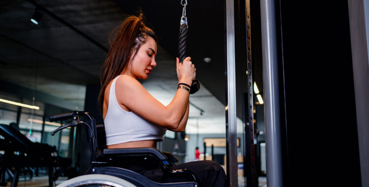 Adaptive athlete in a wheelchair lifting weight