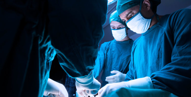 concentrated professional surgical doctor team operating surgery a patient in the operating room at the hospital. healthcare and medical concept.