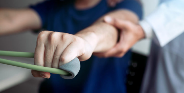 physical therapist descent working with patient doing stretching