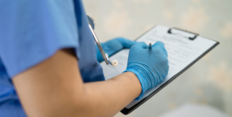 wearing face shield and PPE suit new normal to check patient protect safety