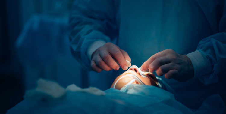 Surgeon wearing gloves operates women's nose, Nose Surgery, ENT surgery, Otolaryngology surgery