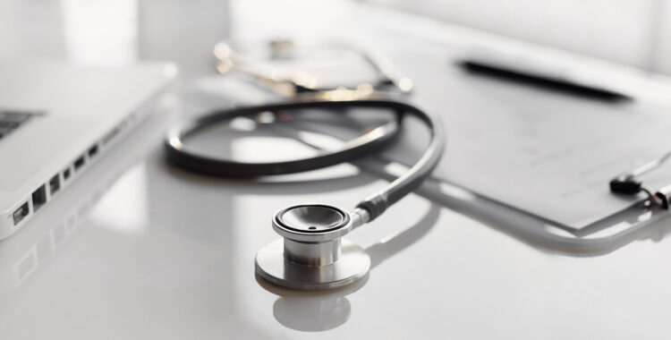 Work place of doctor, physician, therapist or practitioner, focus on stethoscope, panoramic banner