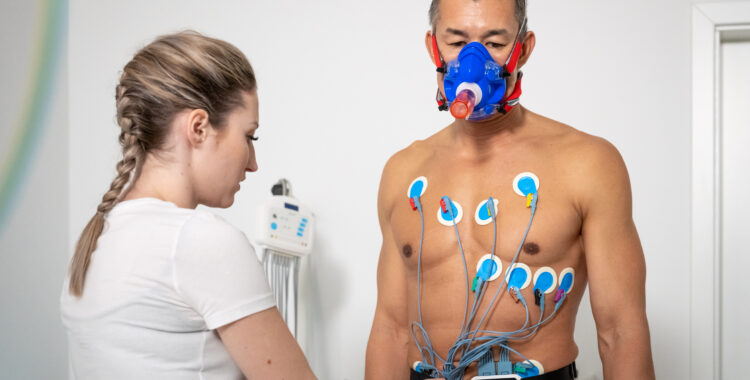 Female doctor placing electrodes on the chest of a man