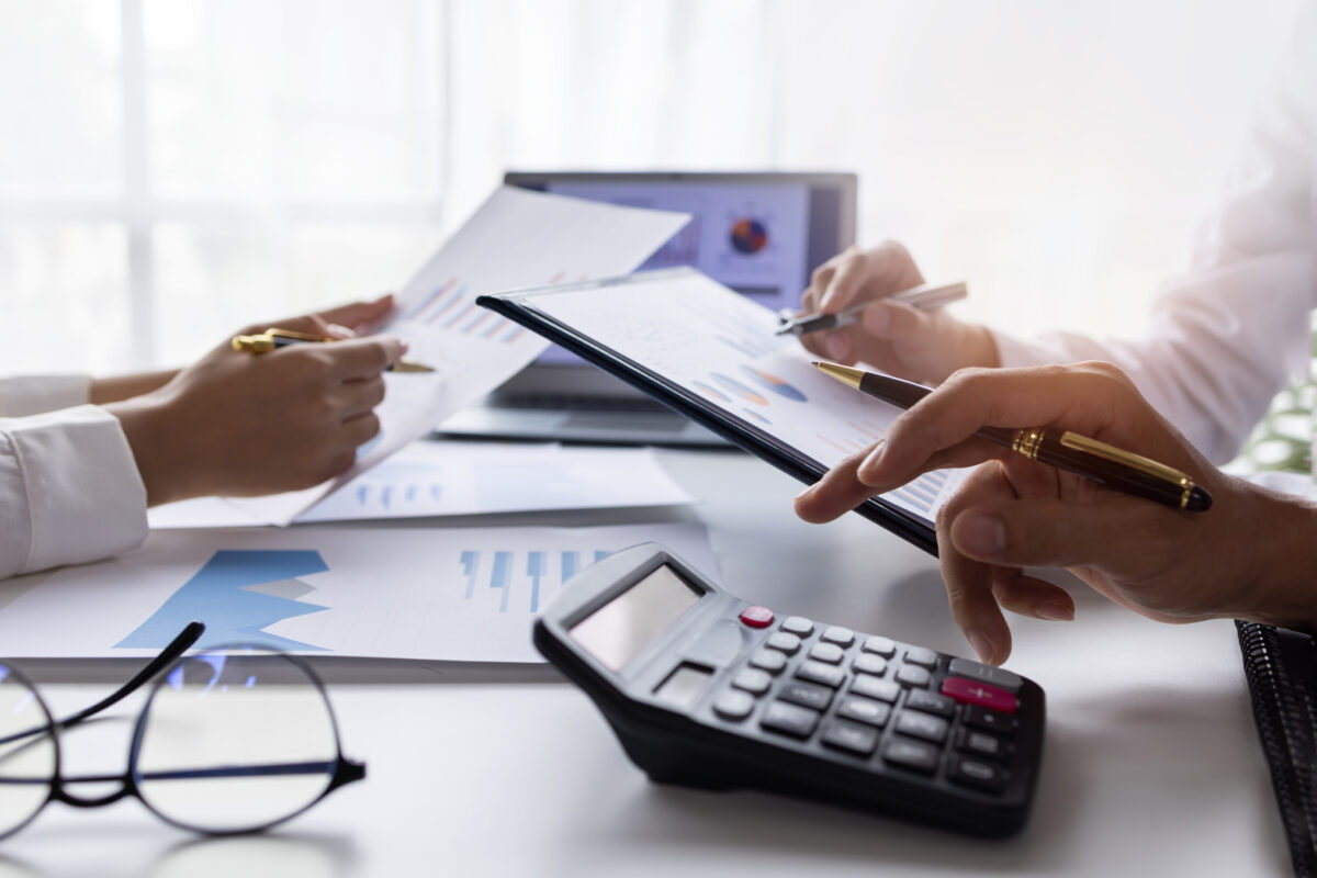 Team of Business people working at workplace with tablet and document, doing planning analyzing Tax financial report, business plan investment, finance analysis Economic business discussions.