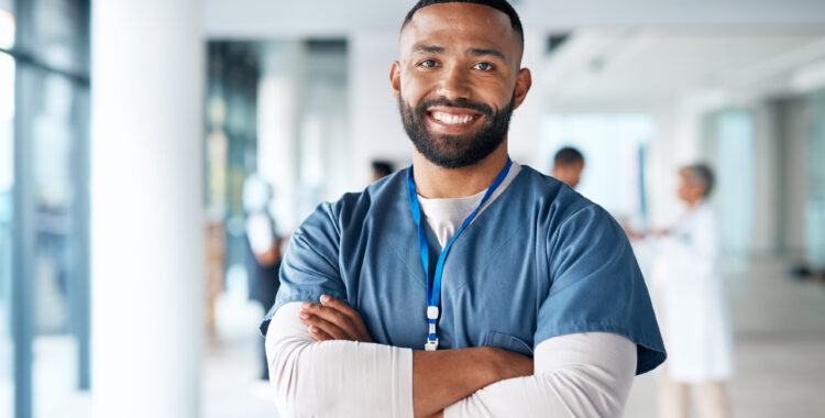 Nurse, hospital employee and portrait of black man in a healthcare, wellness and clinic feeling proud. Happy, smile and doctor in a medical facility with happiness from workplace vision and success