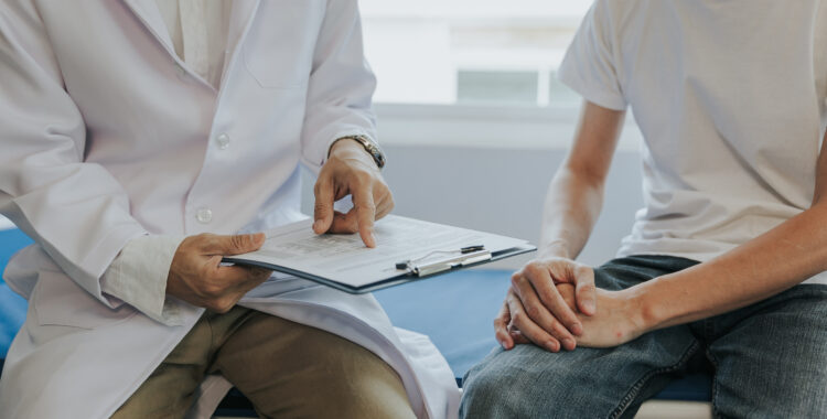 Male health concepts. The young man with pain consulted a doctor for treatment. The doctor is interviewing and advising the patients.
