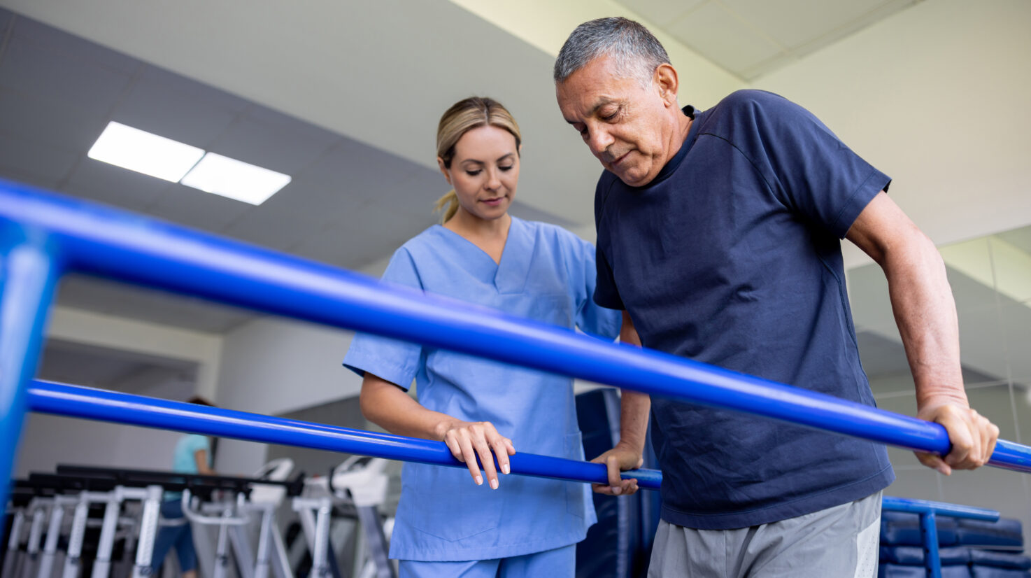 Man doing physical therapy and walking on bars