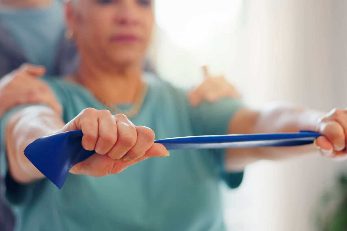 Resistance band, physiotherapy and hands of woman for consulting, medical service and wellness. Healthcare, chiropractor and physical therapist with patient for rehabilitation, recovery and mobility