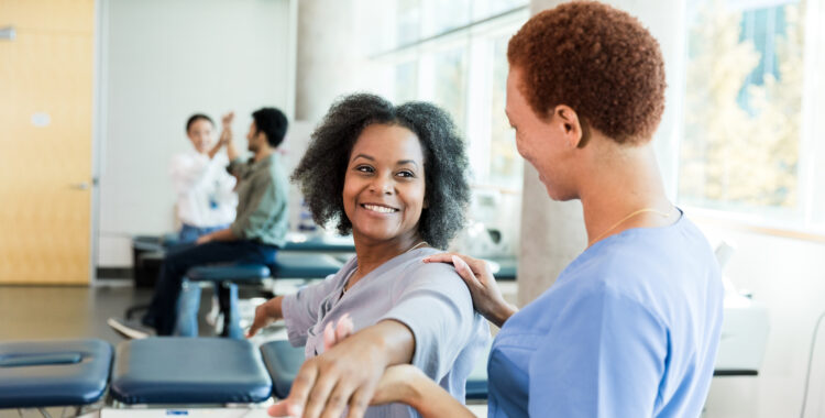 Physical Therapist Assisting Patient with Arm Exercises