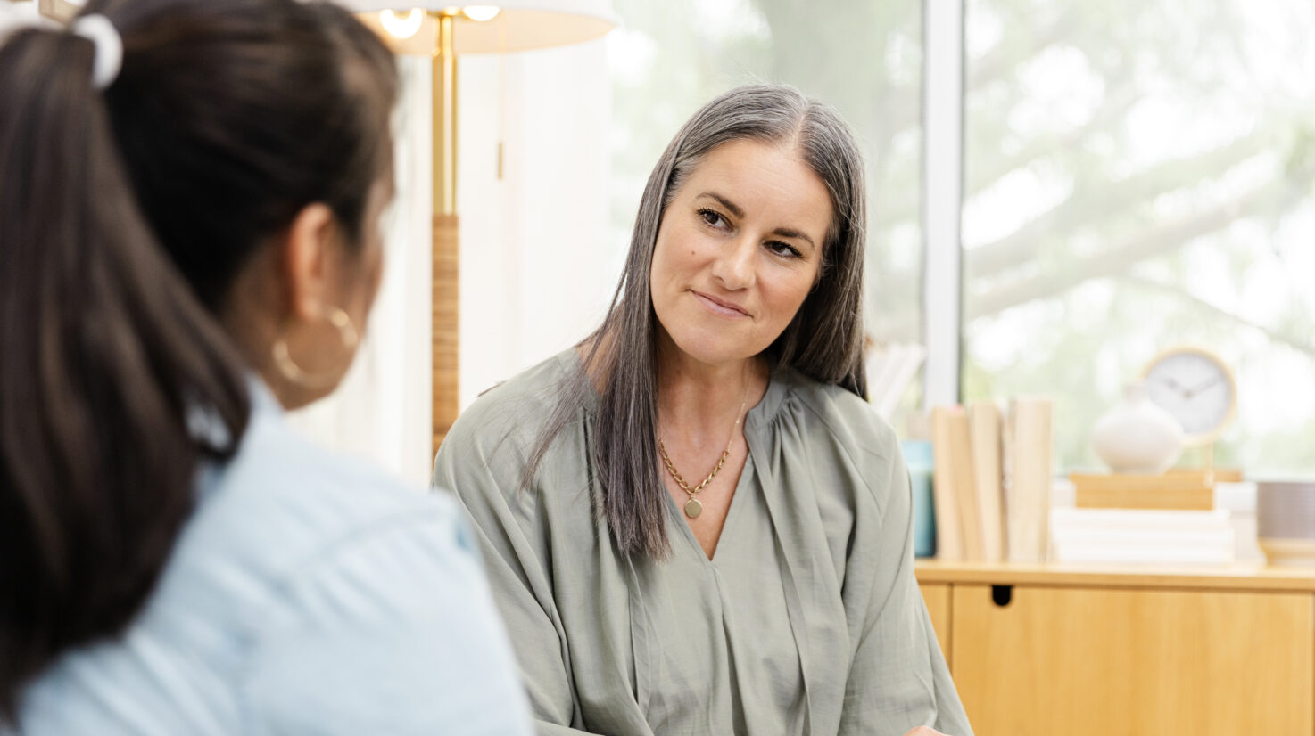 Female counselor listens non-judgmentally to unrecognizable female client