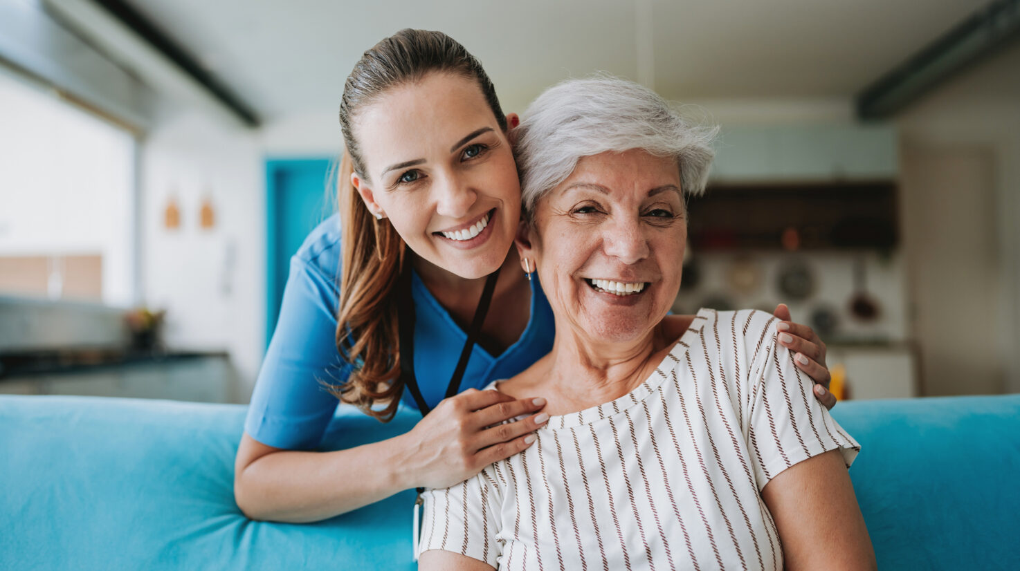 Home care healthcare professional hugging senior patient