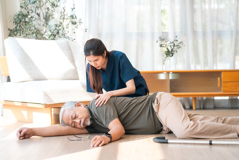 Caregiver beside stroke victim, waiting for help to arrive