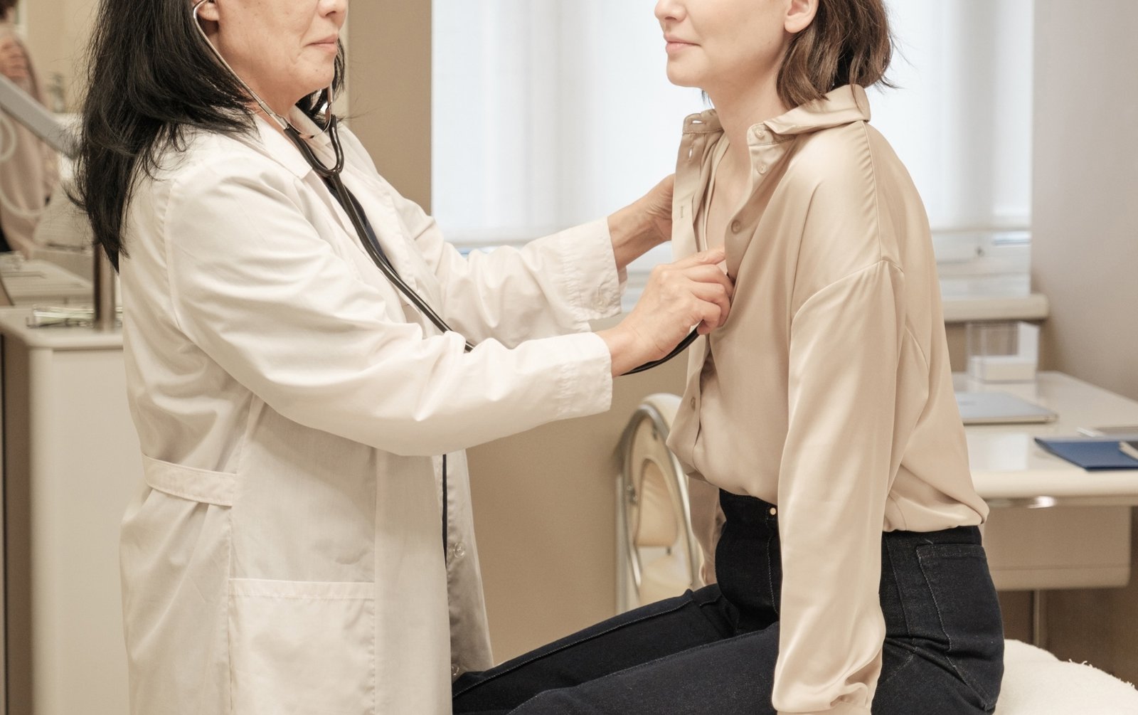 Middle-aged woman and doctor testing for perimenopause symptoms