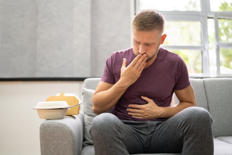 Man getting heartburn after eating