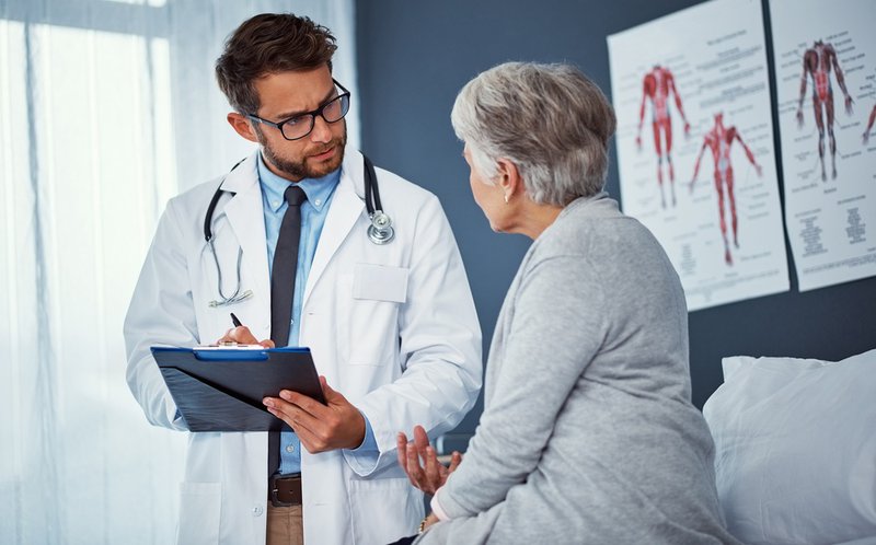 Senior woman receiving same day primary care from male physician