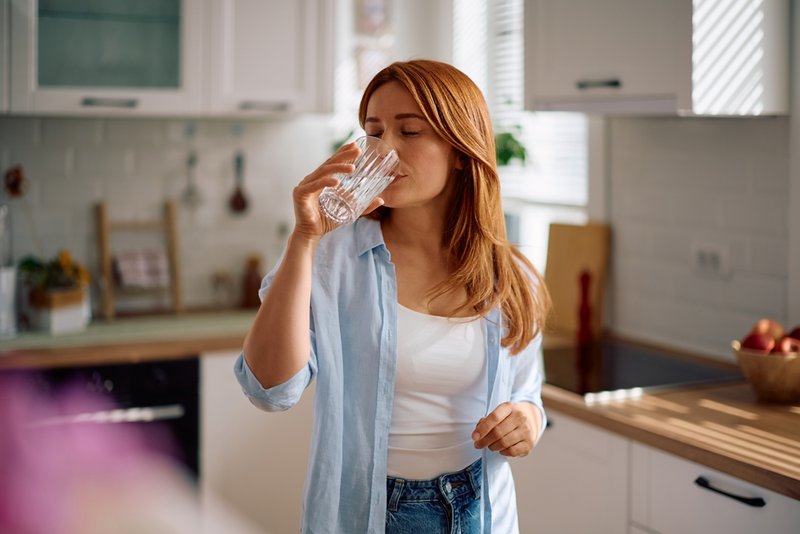 Healthy woman drinking water