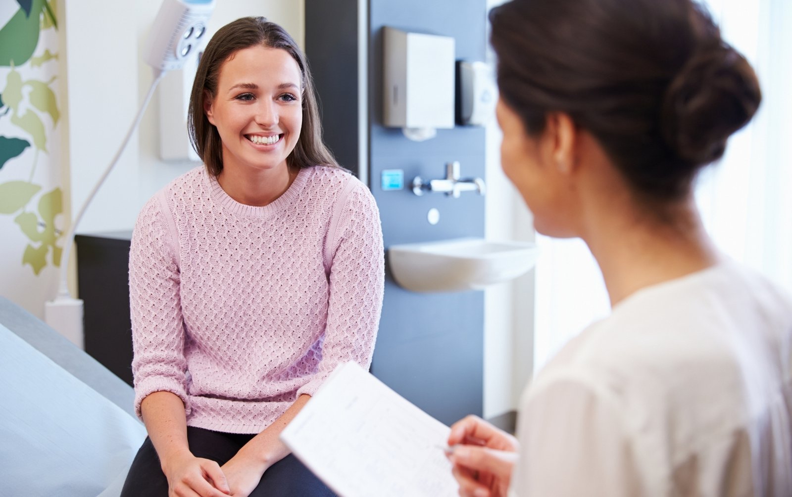Young woman with her health provider for a checkup