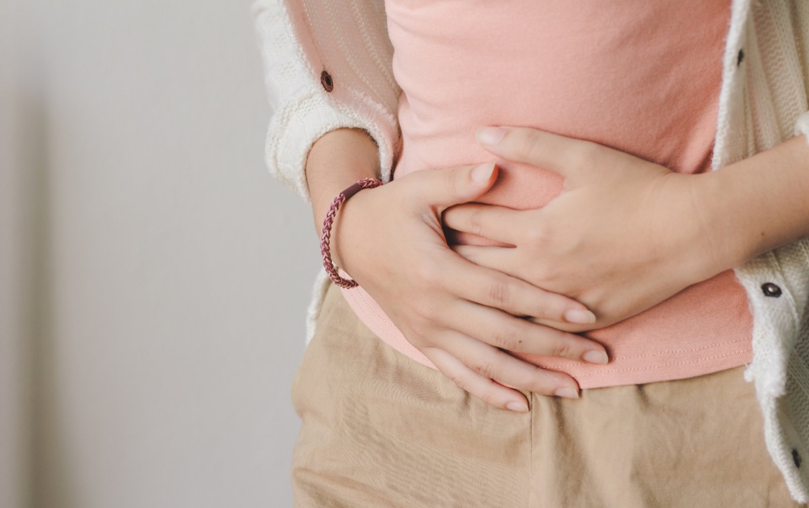 Woman holding her belly, suffering from bloating