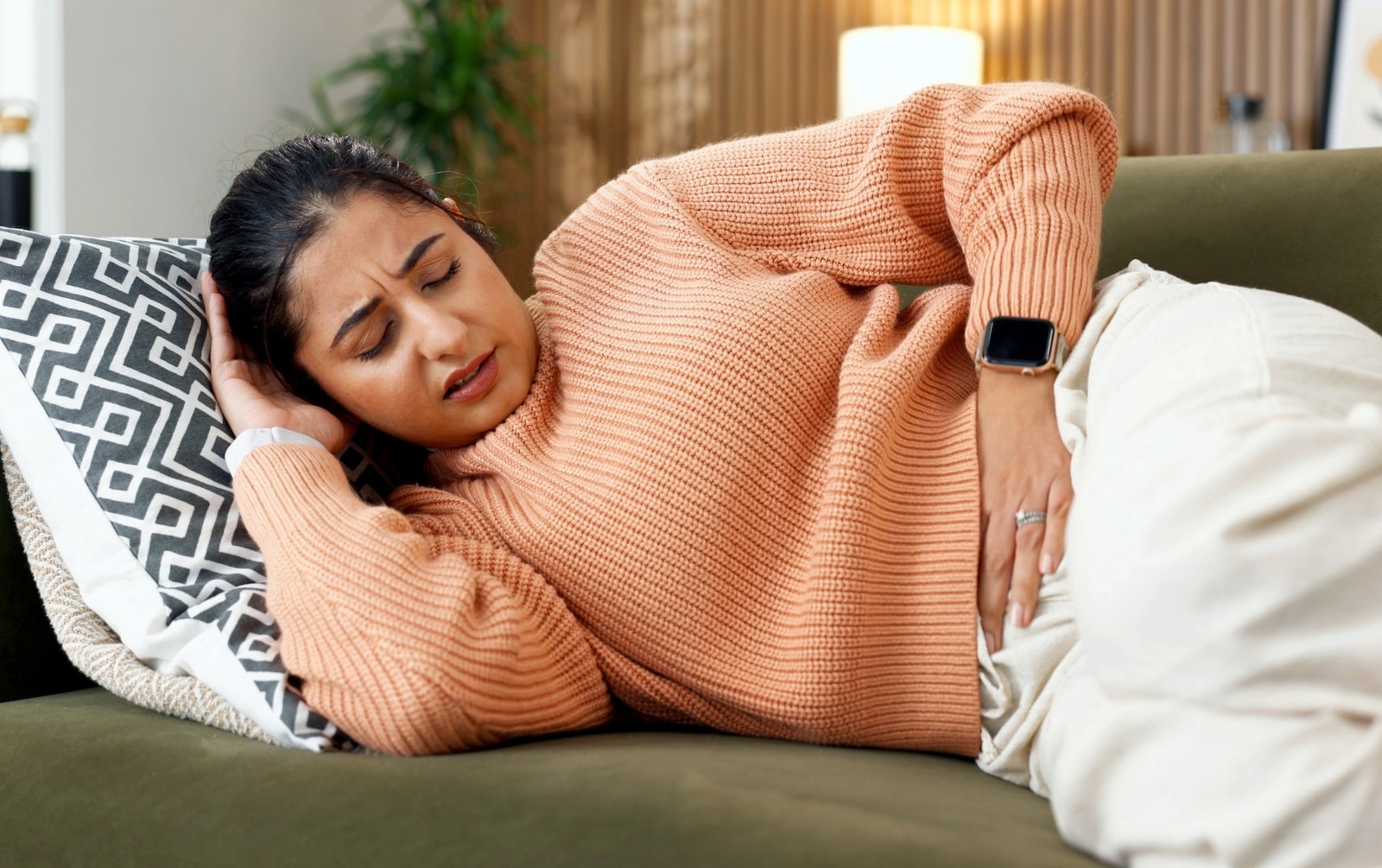 Woman with abdominal pain and cramping, symptoms of IBS in women