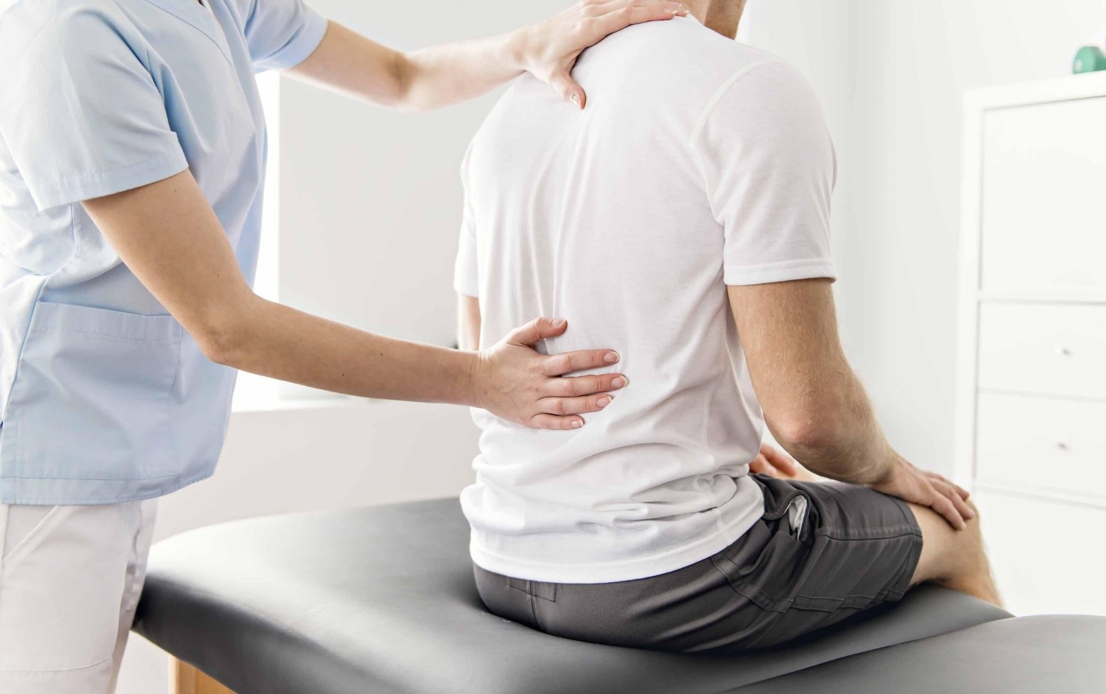 Man with back pain and his healthcare provider