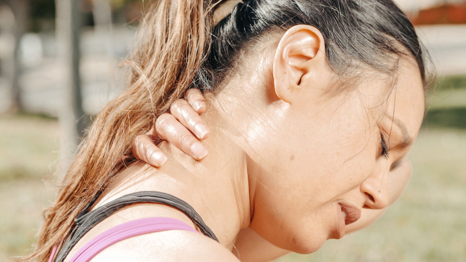 Woman suffering from muscle strain in her neck