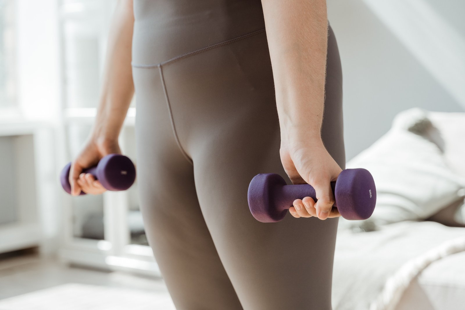 Woman lifting light weights to help improve joint health.